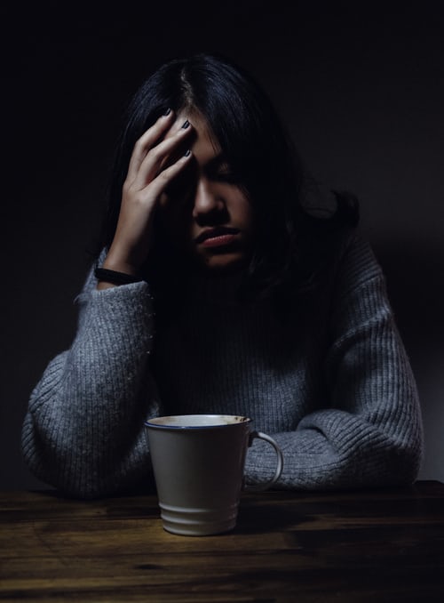 a girl holding her head